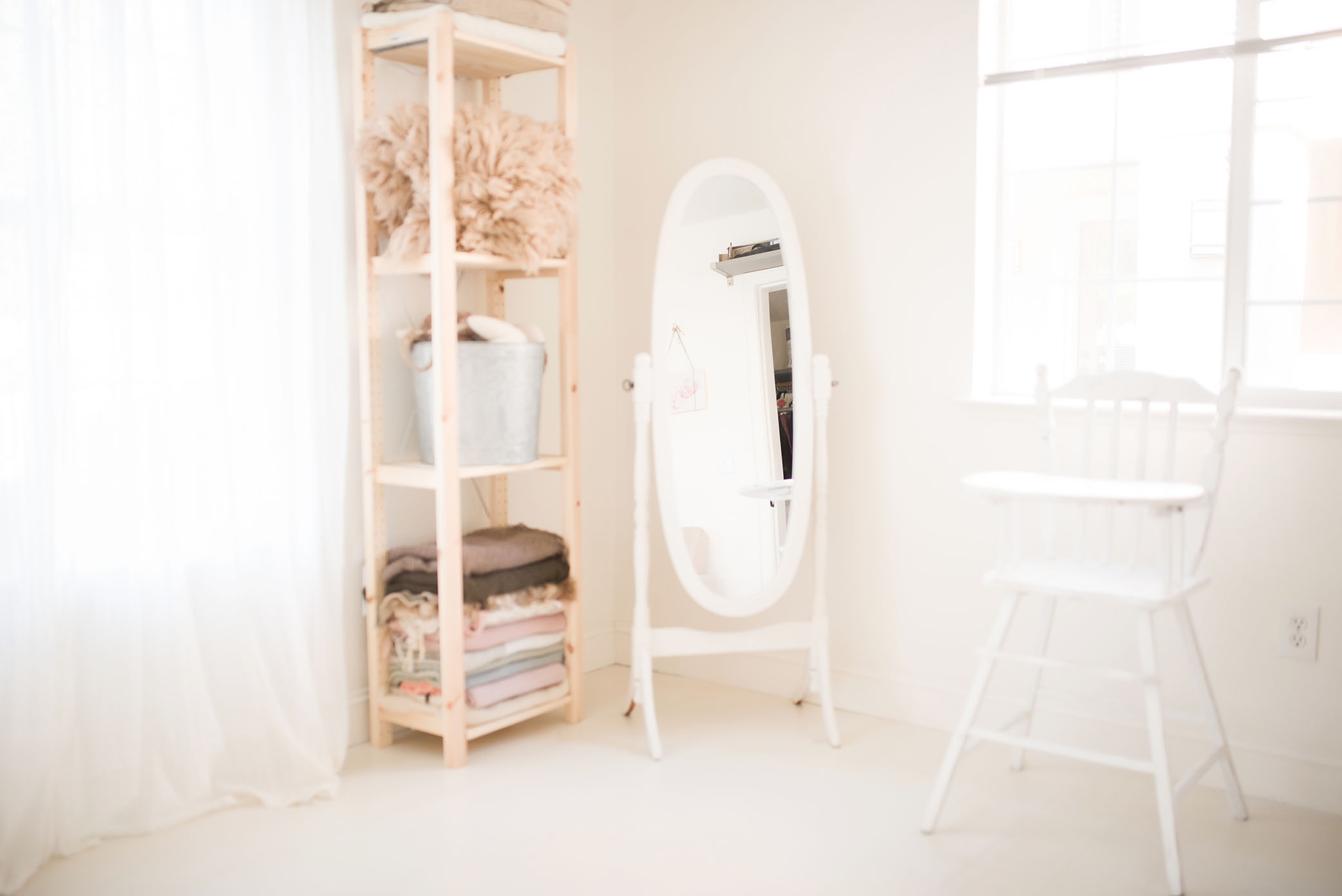 A mirror is placed next to a shelf in a bright room, captured by Sweet Beginnings Photography by Stephanie, a Sacramento Newborn and Family Photographer