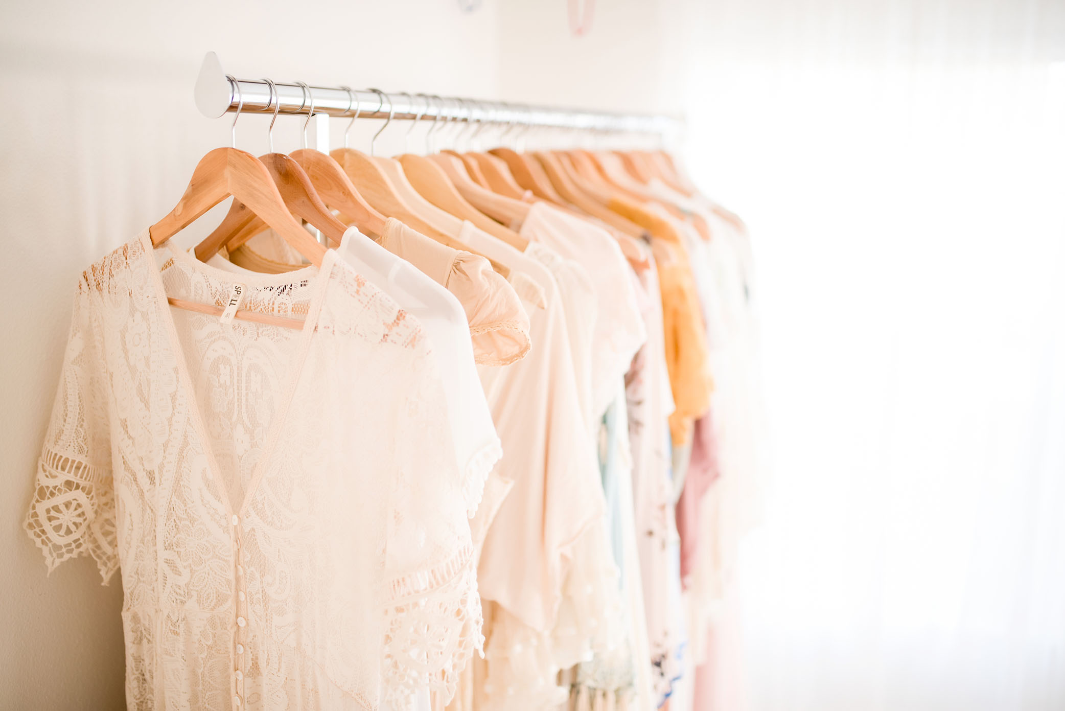 Clothes hang on a rack, captured by Sweet Beginnings Photography by Stephanie, a Sacramento Newborn and Family Photographer