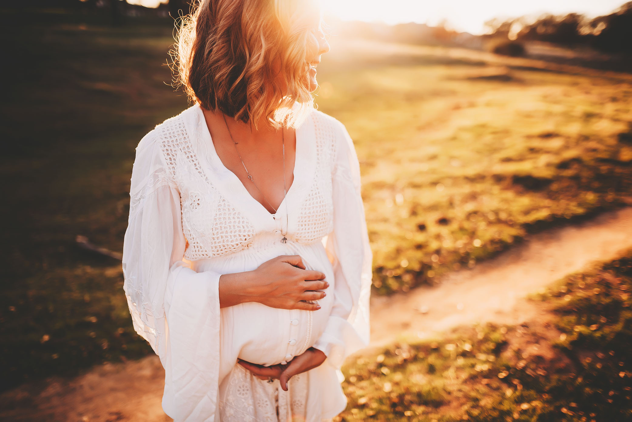 A woman holds her belly in the sun | Sweet Beginnings Photography by Stephanie | Sacramento Family Photographer