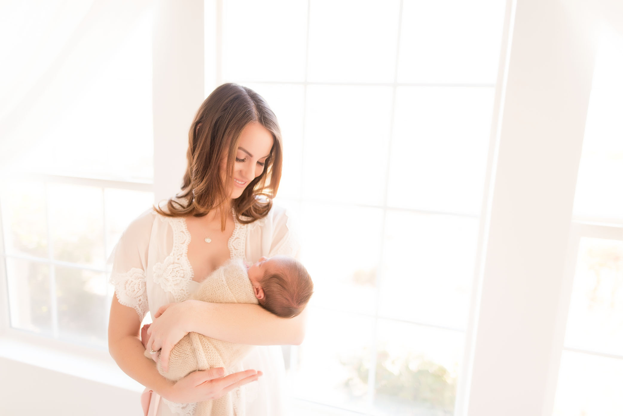 A mother holds her newborn | Sacramento Newborn And Family Photographer 