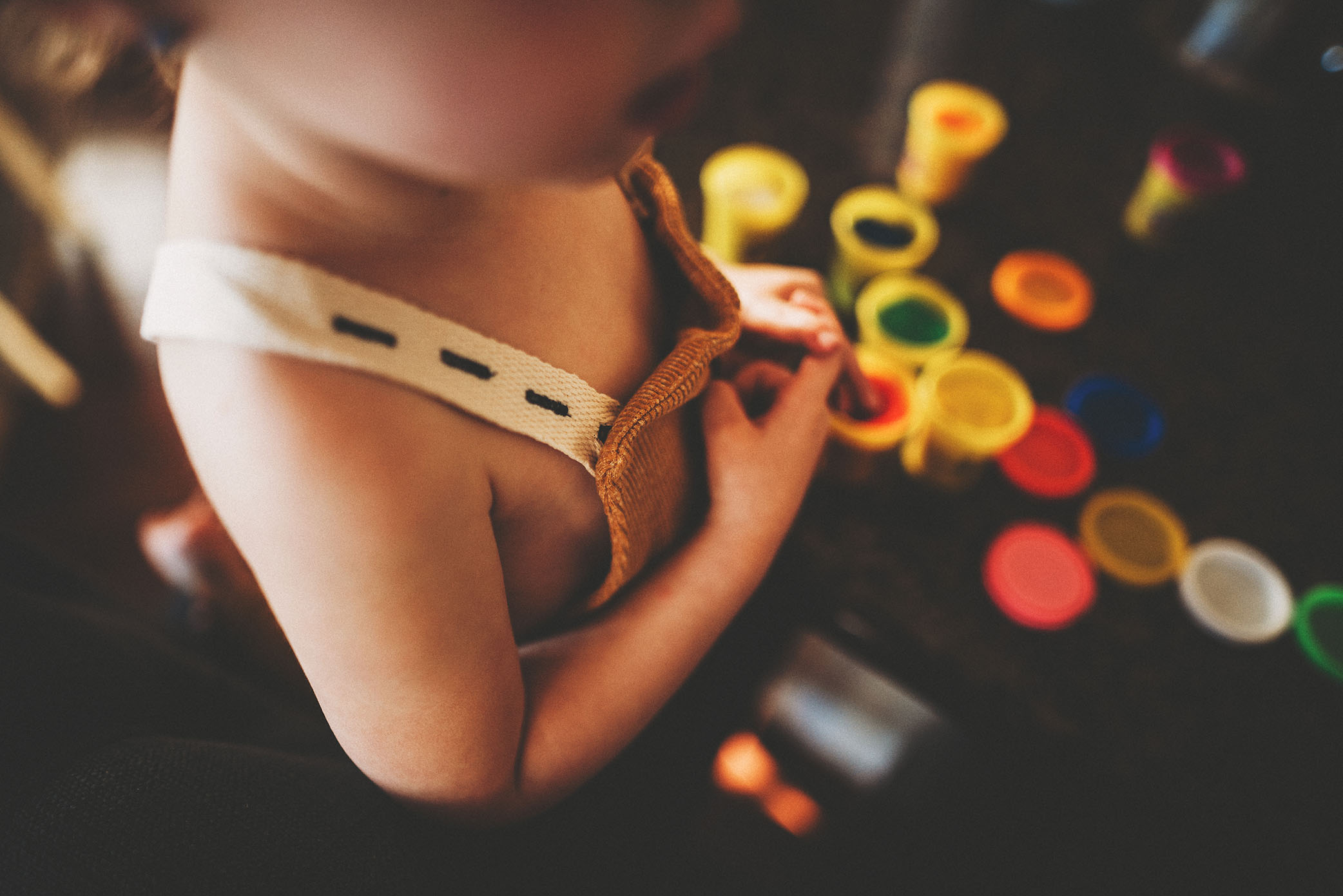 A girl plays with play doh, captured by a family photographer in Sacramento. 