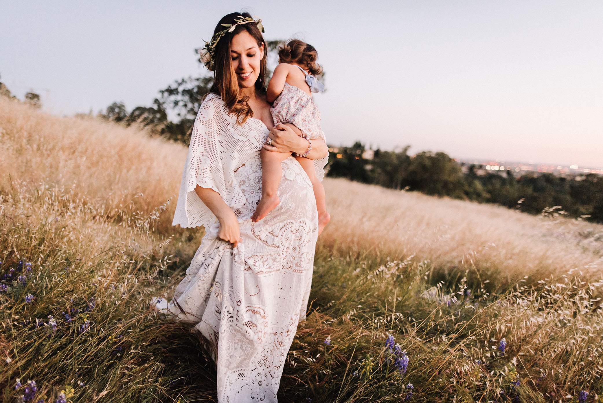 Mom holds daughter at sundown captured by Sweet Beginnings Photography by Stephanie