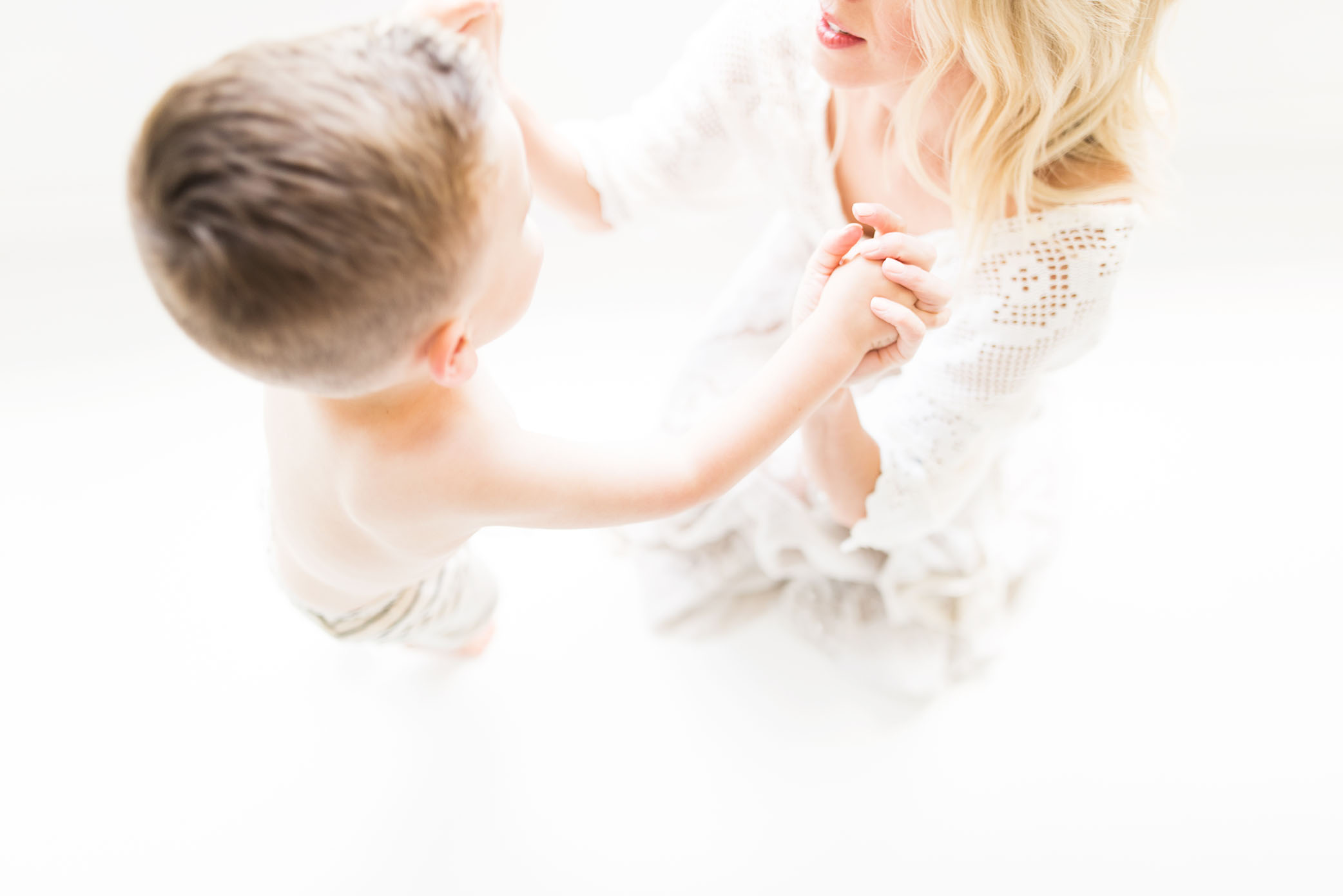 Mom holds son's hands lovingly captured by Sweet Beginnings Photography by Stephanie