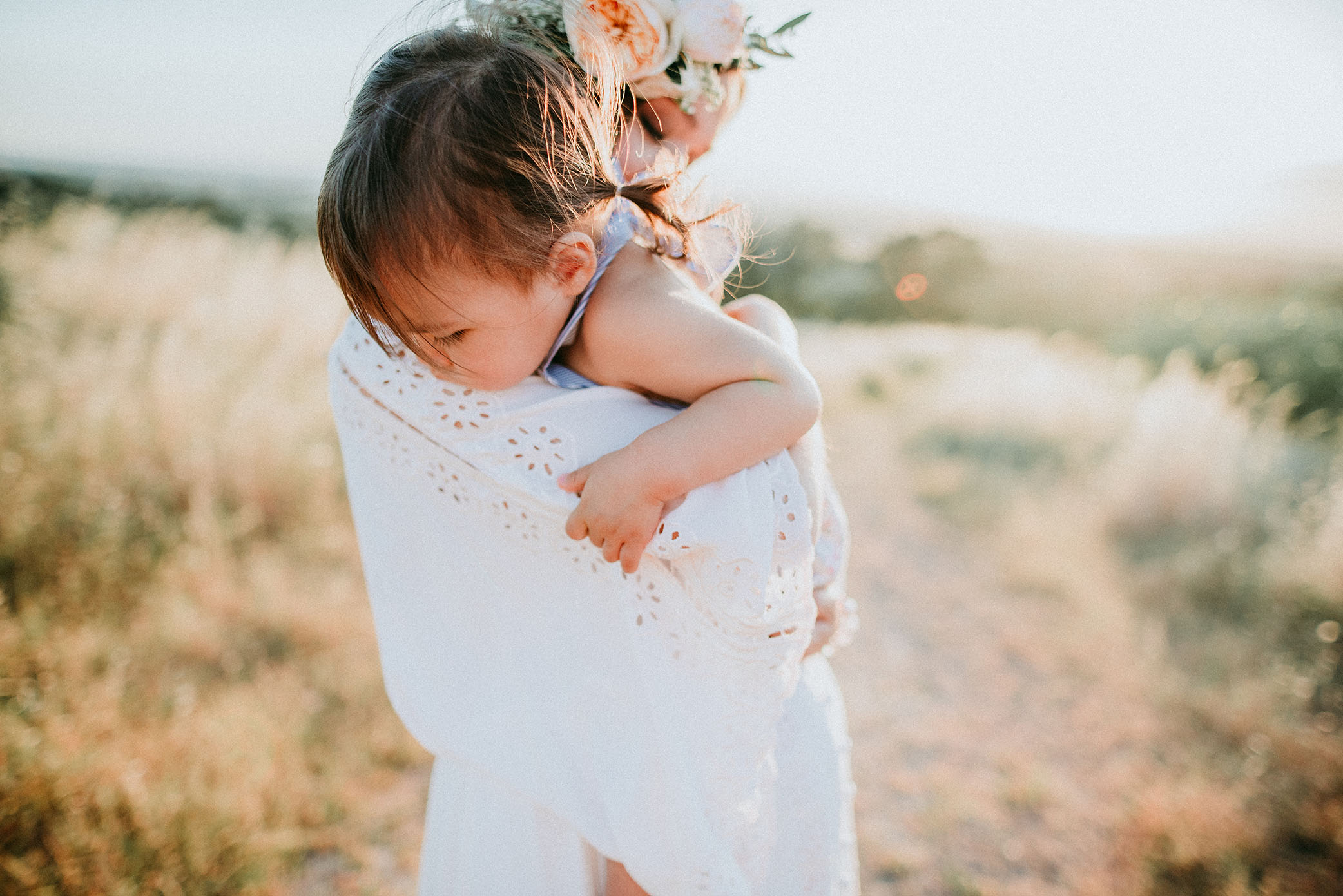 Daughter snuggles mom captured by Sweet Beginnings Photography by Stephanie